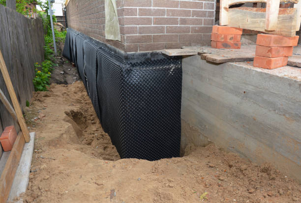 SJ Waterproofing Pros technician performing targeted Basement Waterproofing assessment in Lyndhurst, NJ